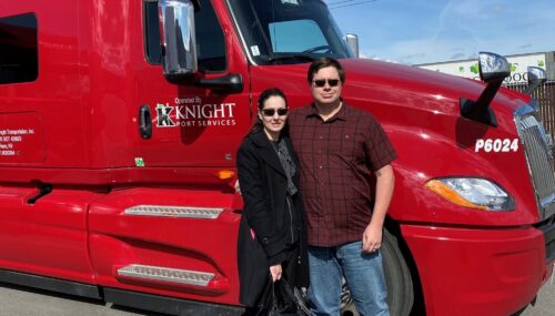 Two experienced truck drivers in front of a knight transportation truck