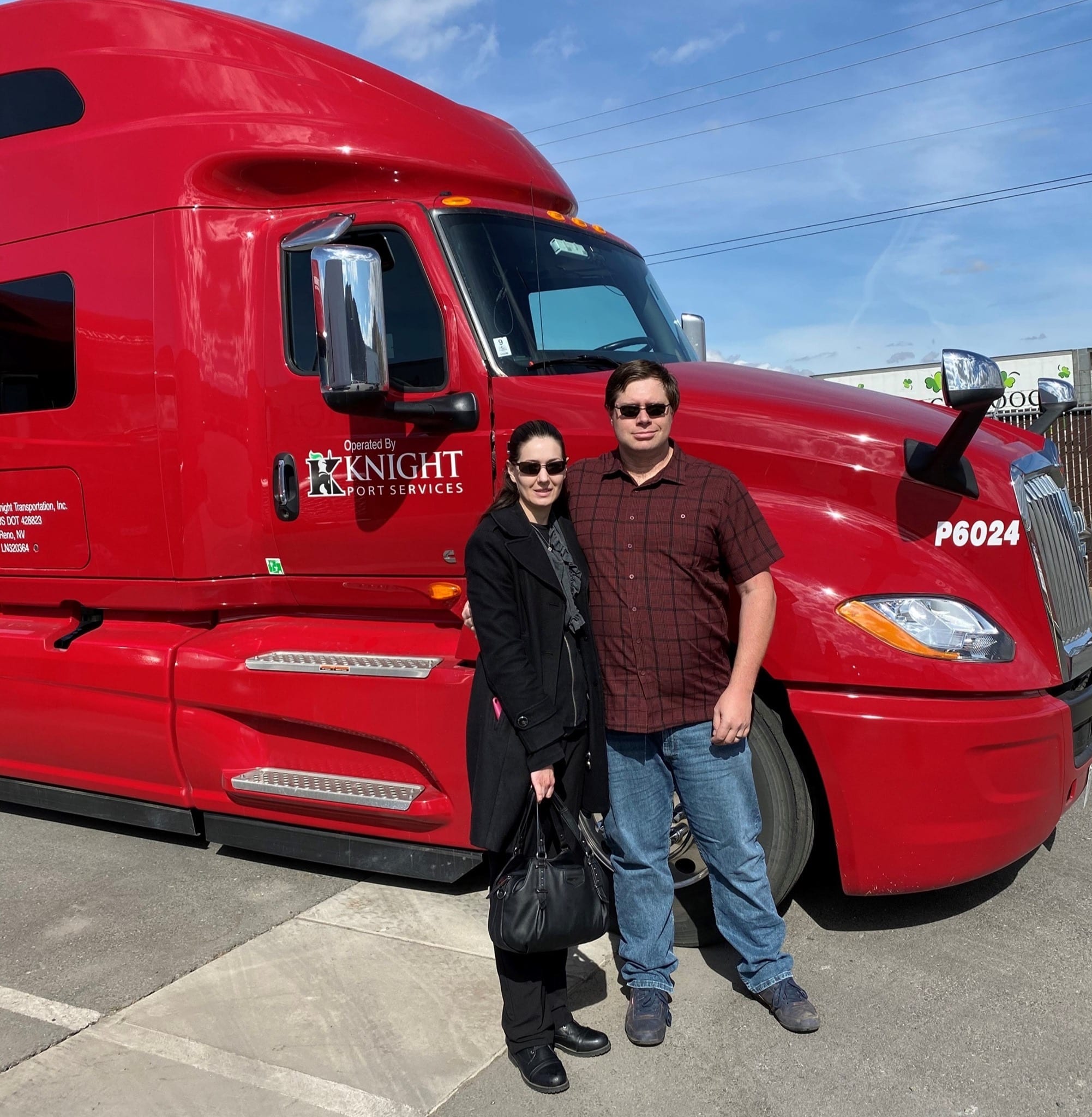 Two experienced truck drivers in front of a knight transportation truck