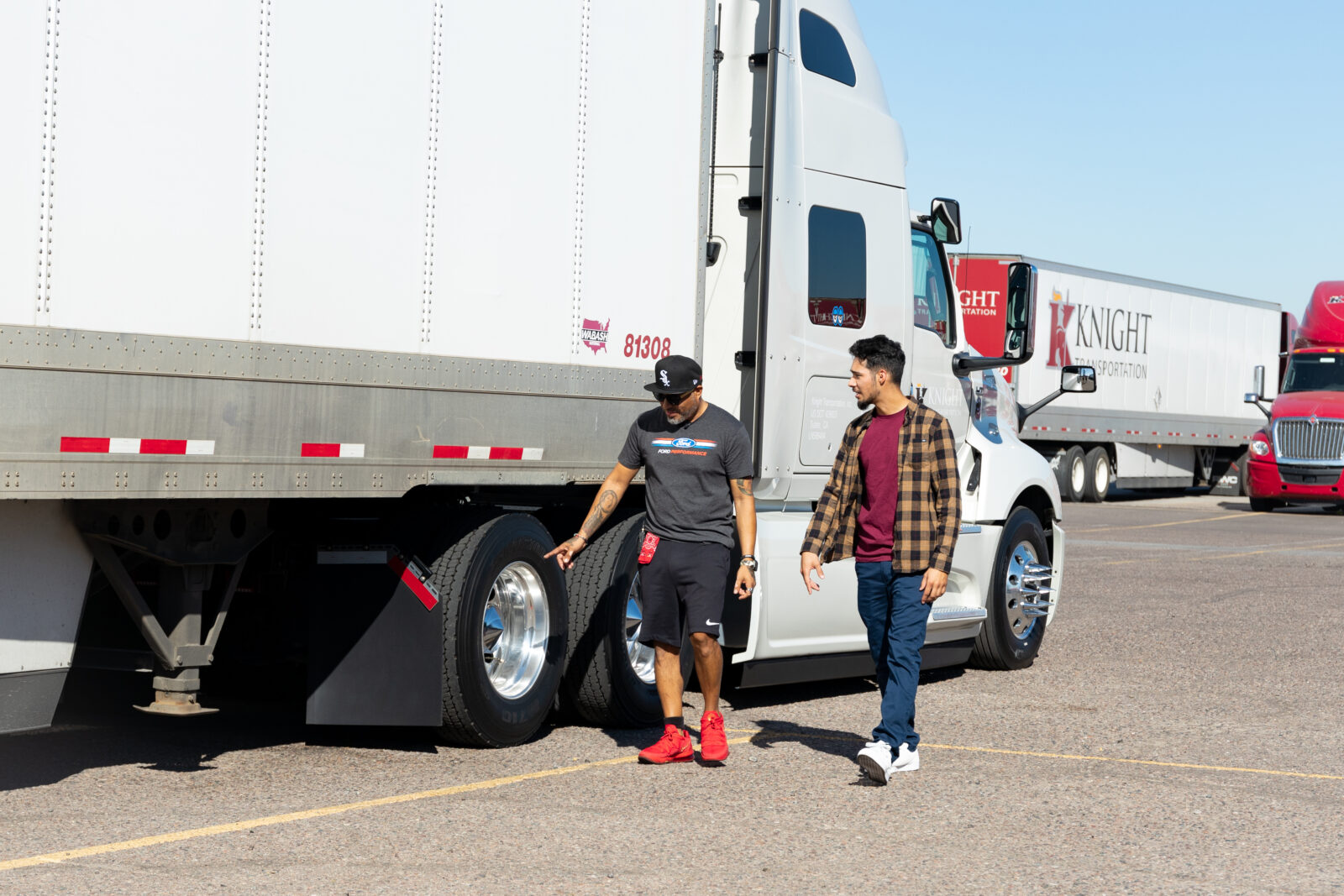 Knight Transportation trainer and trainee examine a truck.